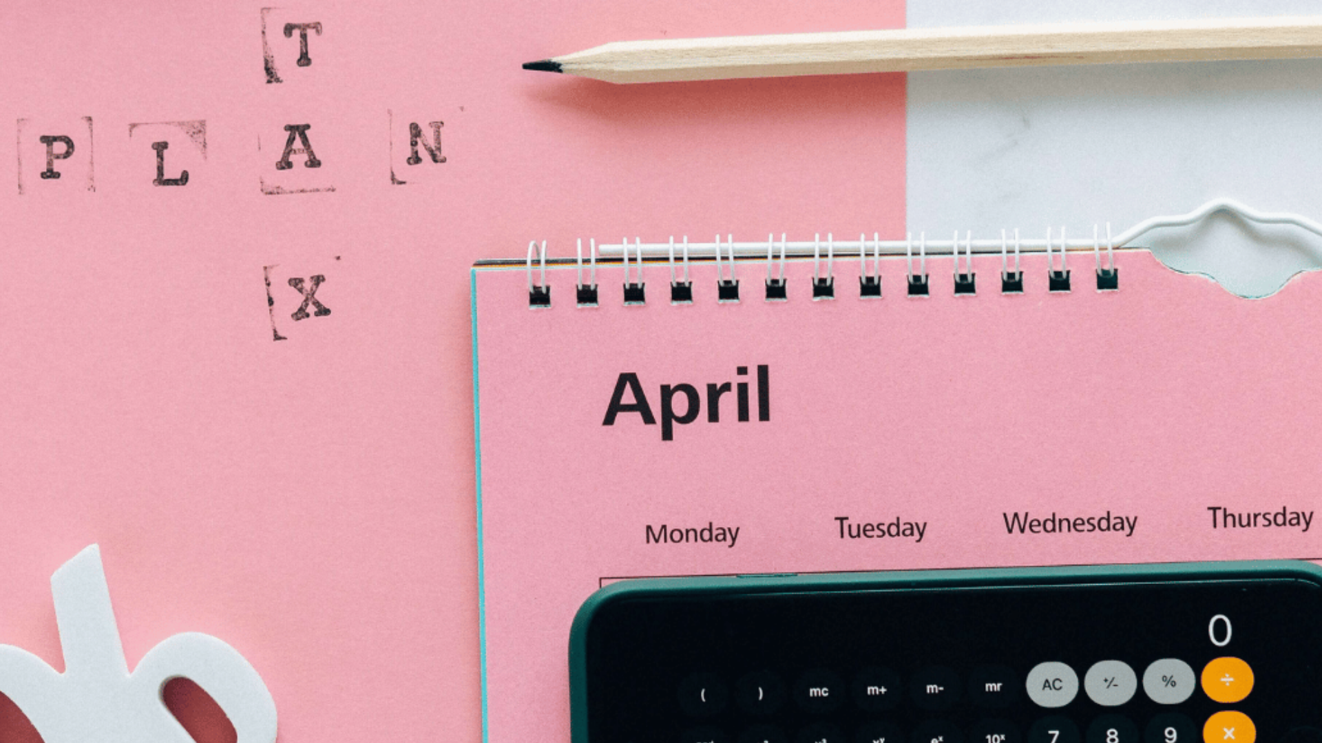 A pink calendar displays the month of April, with a calculator hiding the dates and 'Tax plan' stamped in the upper left corner.